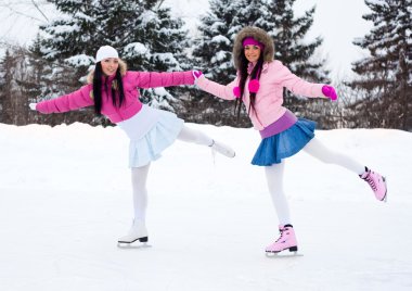 Two girls ice skating clipart