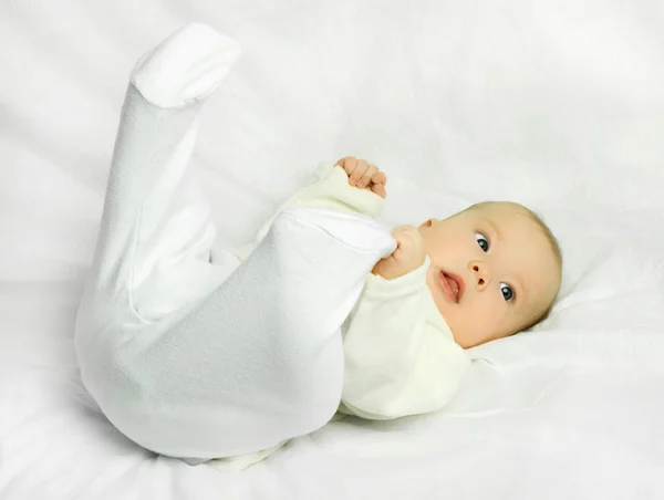 Cute baby on the white sofa — Stock Photo, Image