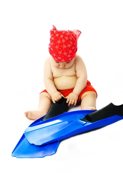 Baby putting on flippers — Stock Photo, Image