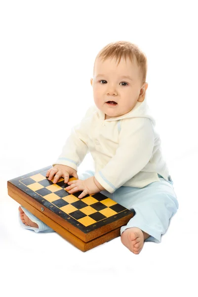 Baby with a chessboard — Stock Photo, Image