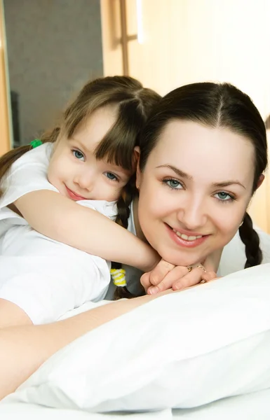 Mother and daughter on the bed — Stock Photo, Image