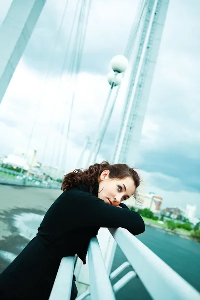 Lonely girl on the bridge — Stock Photo, Image