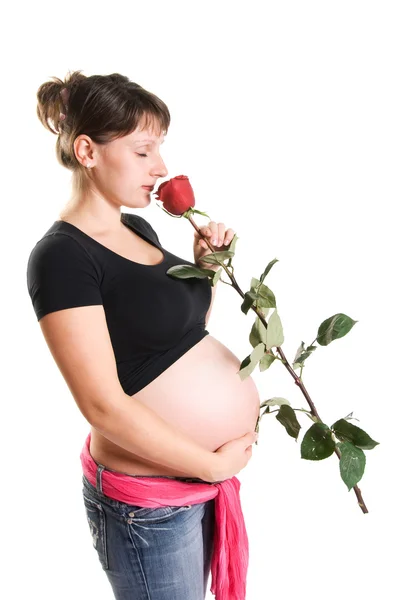 Těhotná žena s růží — Stock fotografie
