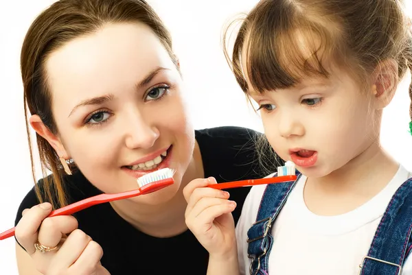 Anne ve kızı dişlerini fırçalıyor. Stok Fotoğraf