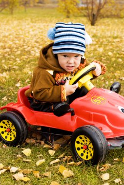 Boy driving a car clipart