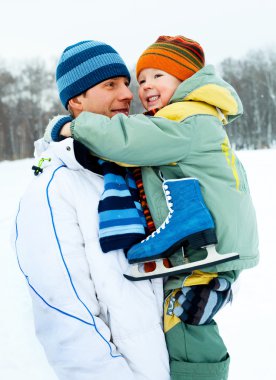 Father and son go ice skating clipart