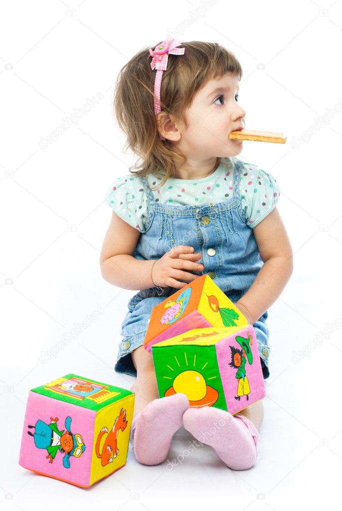 One year old girl playing with her toys
