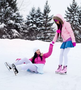 Two girls ice skating clipart