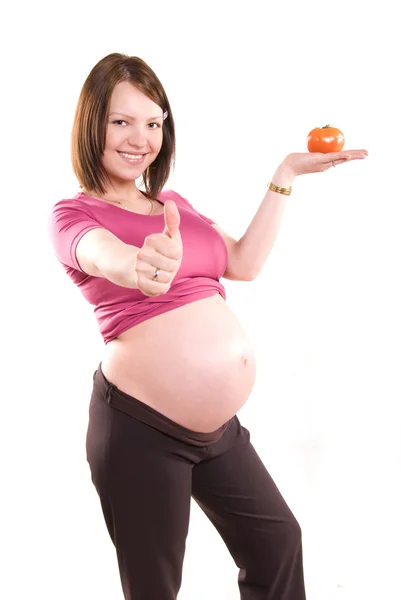 Mulher grávida com um tomate — Fotografia de Stock