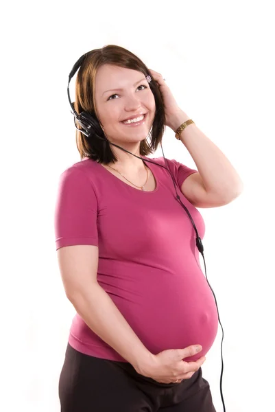 Femme enceinte écoutant la musique — Photo