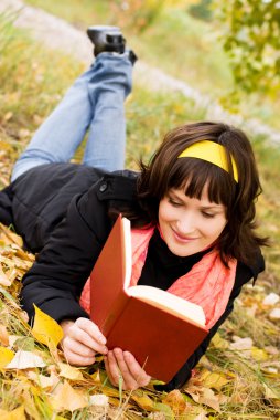 Pretty girl reading a book clipart