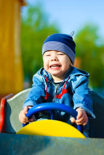 Happy boy driving a toy car — Stock Photo, Image