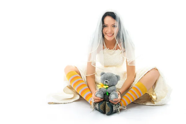 Funny bride wearing sporting shoes with a toy — Stock Photo, Image