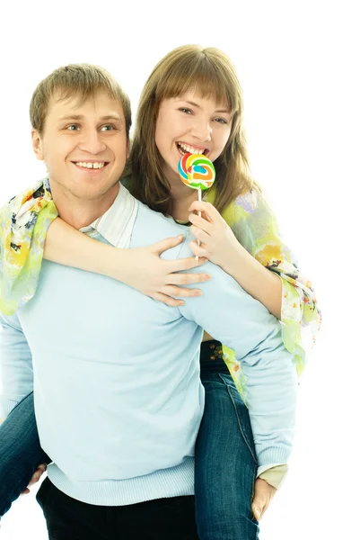 Young man giving his girlfriend piggyback ride — Stock Photo, Image