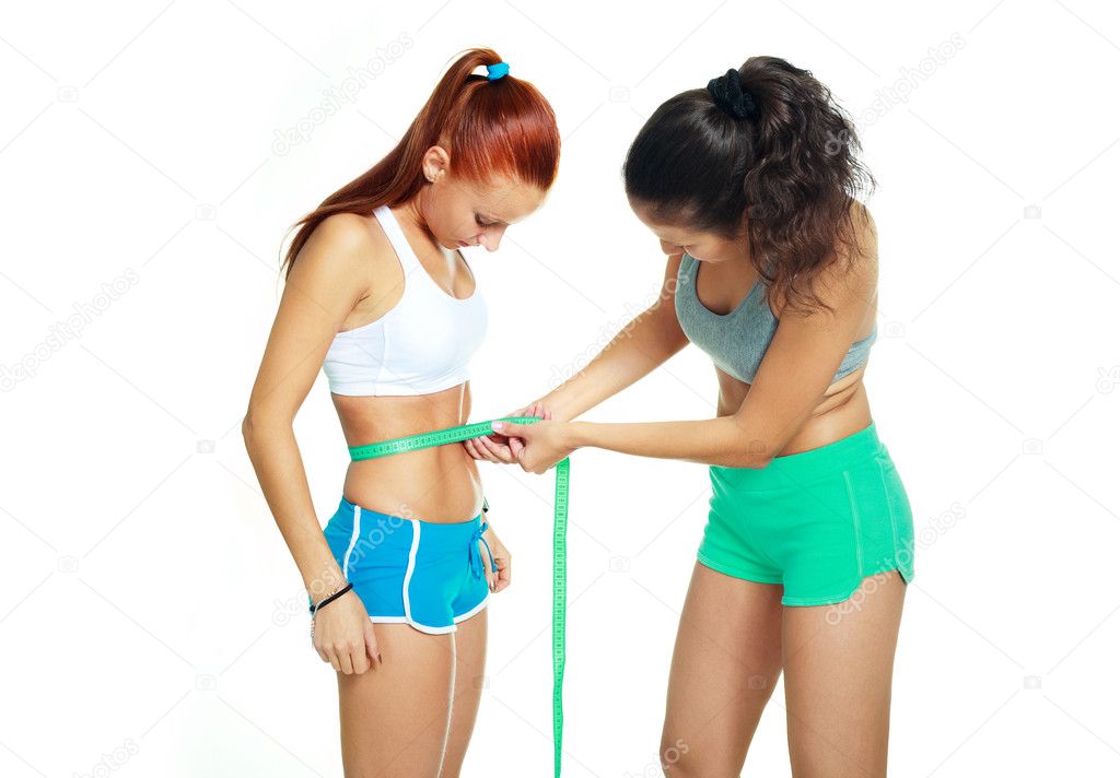 Women measuring waist with a tape