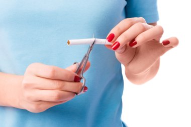 Woman cuts a cigarette clipart