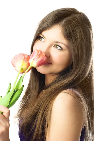 Pretty girl smelling tulips — Stock Photo, Image