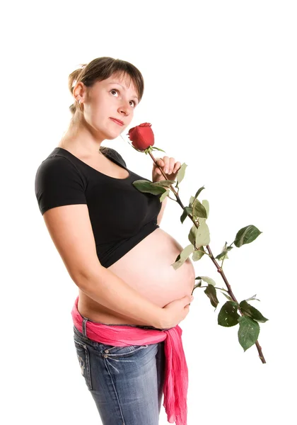 Беременная женщина с розой — стоковое фото