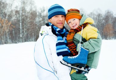 Father and son go ice skating clipart