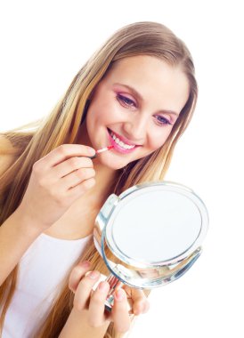 Woman applying lip gloss clipart