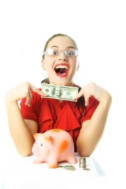 Excited woman puttting money into her piggy bank clipart