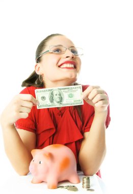 Woman putting money into her piggy bank