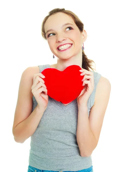 Meisje met een hart-vormige kussen — Stockfoto