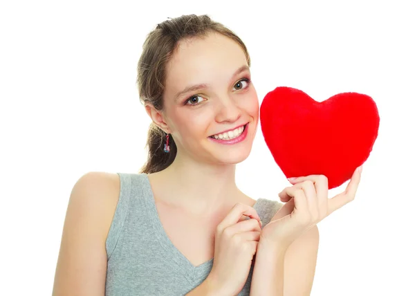 Flicka med en hjärtformad kudde — Stockfoto