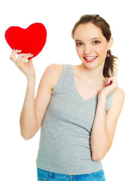 Menina com um travesseiro em forma de coração — Fotografia de Stock