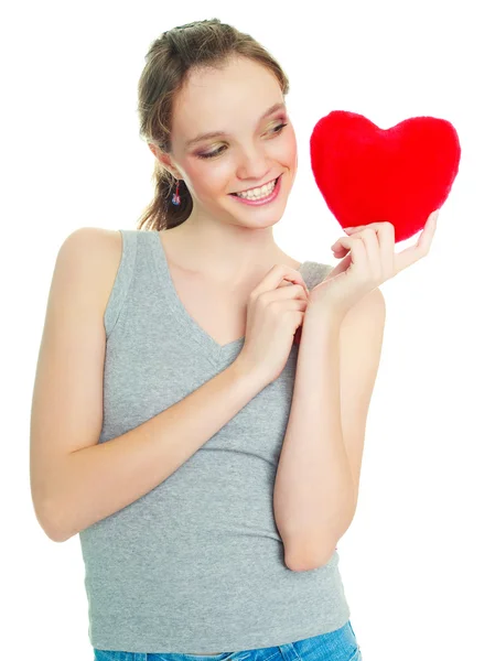 Lány, egy szív alakú párna — Stock Fotó