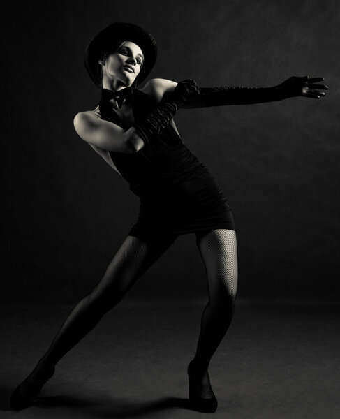 Jazz dancer wearing a black cylinder hat, a butterfly bow tie and gloves