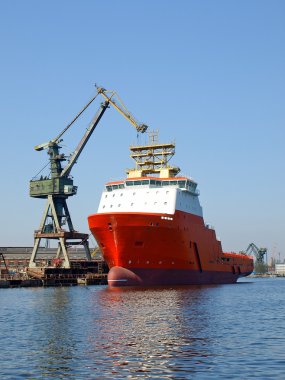 Red tug in shipyard clipart