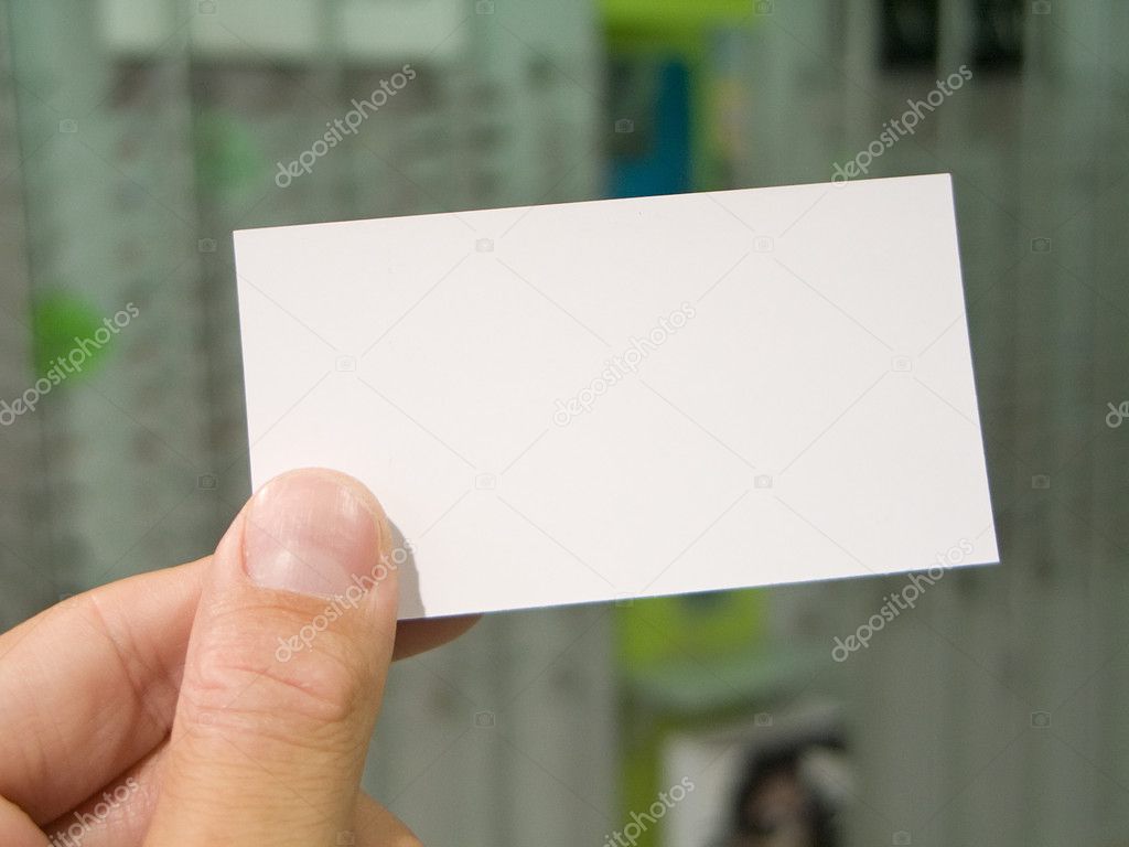 Hand holding blank visit card