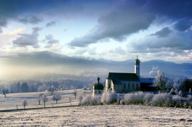 Alpine scenery with church in the frosty clipart
