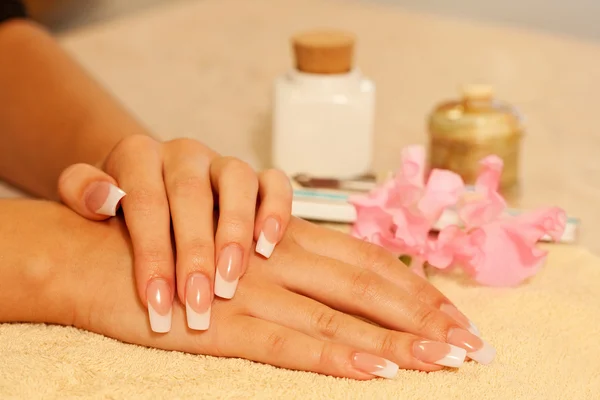 Hands of woman with french manicure — Stockfoto