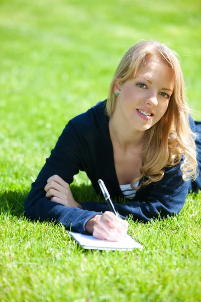 stock image Pretty girl studying on a green meadow