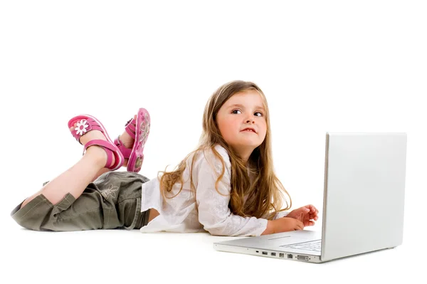 Little girl lying with laptop — Stock Photo, Image
