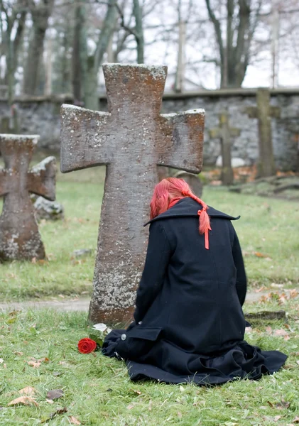 stock image Gothic girl with a rose on a cemetery