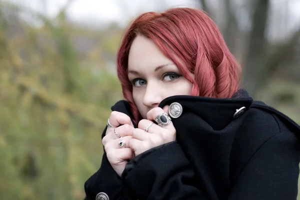 stock image Redhead flirty goth girl in a black coat