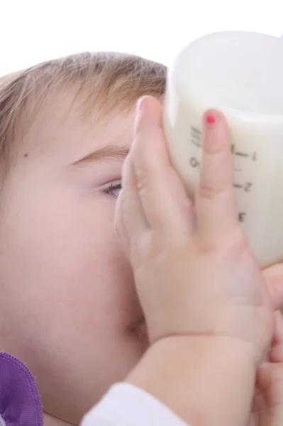 Um bebê com uma garrafa de leite — Fotografia de Stock