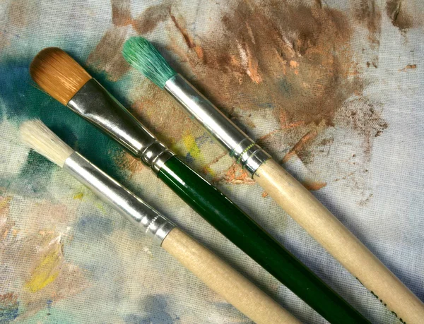 Three brushes on fabric — Stock Photo, Image