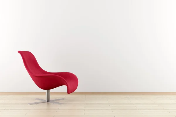 白い壁の前に赤い肘掛け椅子 ストック画像