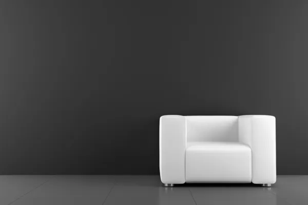 Белое кресло перед черной стеной — стоковое фото