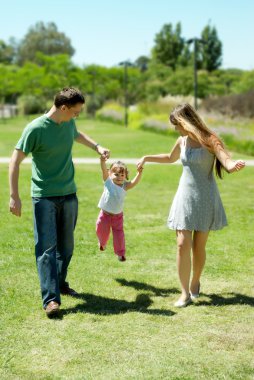 Happy family on walk in park clipart