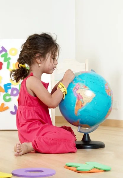 stock image The little girl with globe