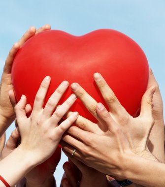 Group of hands holding heart