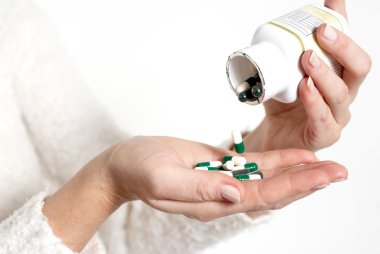 Woman's hands with pills clipart