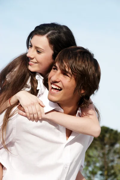 Young couple against the sky — Stock Photo, Image