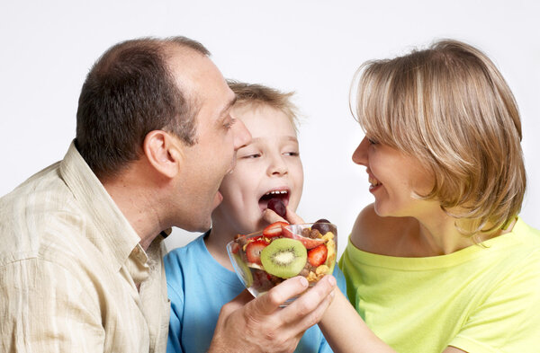 Happy family with fruit salad