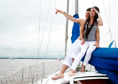 Young couple onboard the yacht clipart